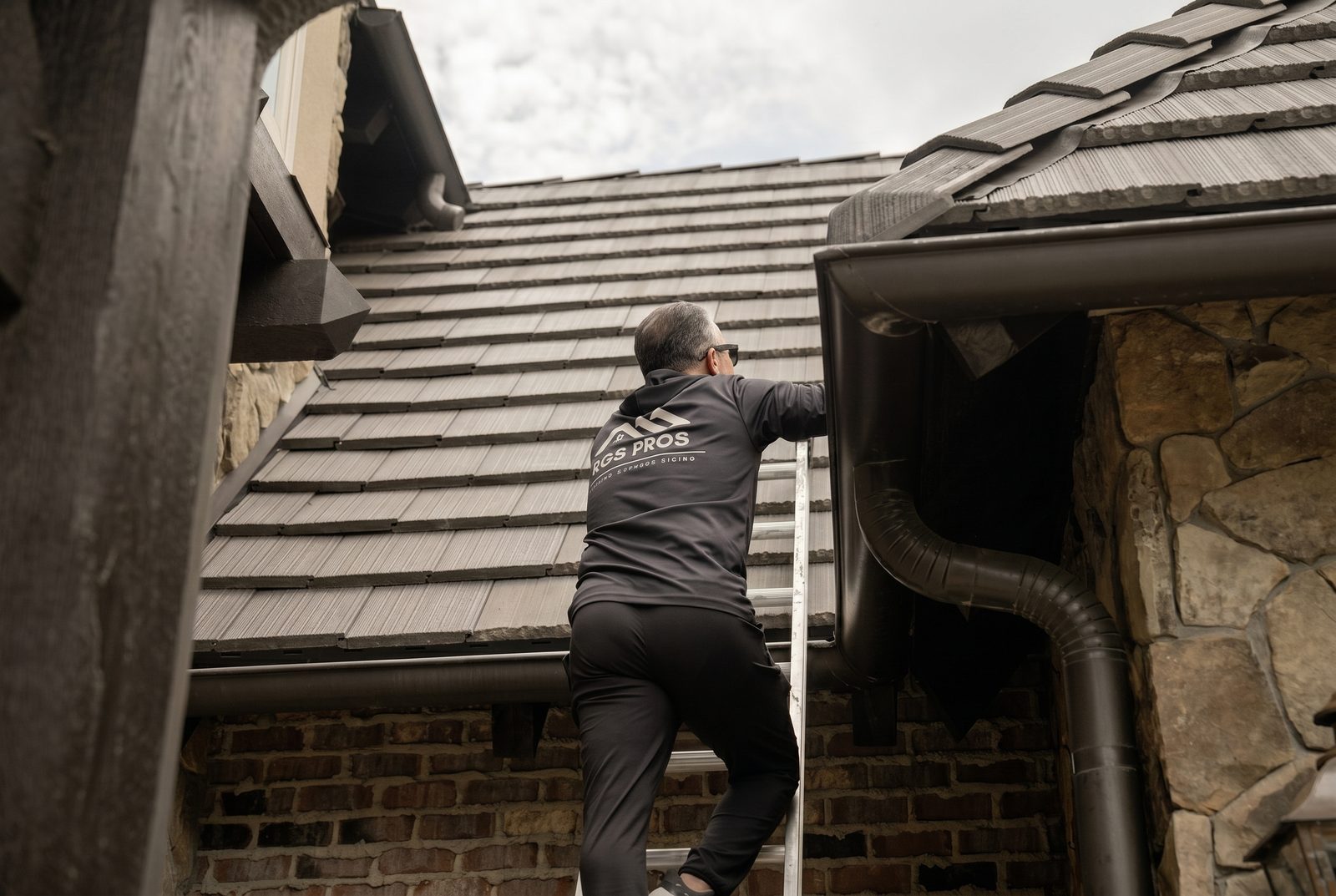 Tony Garay, owner of RGS Home Pros, heading up to inspect a roof